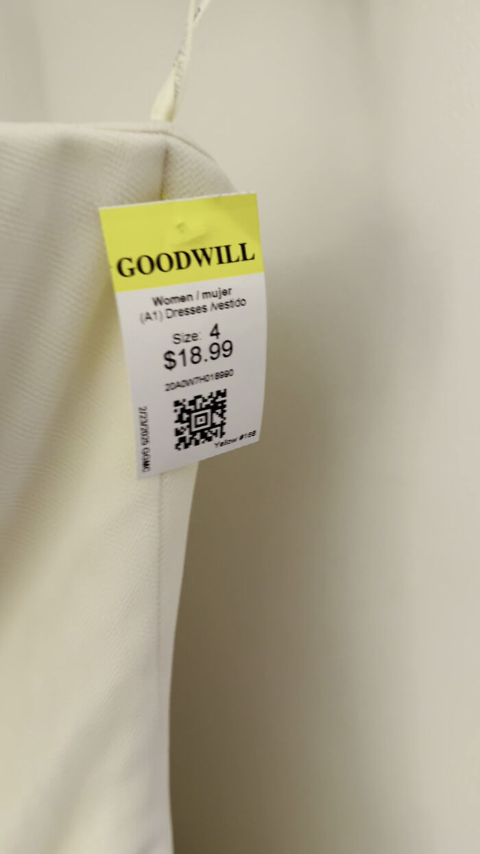Goodwill store dress with a price tag, size 4, linked to Carrie Bradshaw's famous wedding dress. Goodwill store dress with a price tag, size 4, linked to Carrie Bradshaw's famous wedding dress.