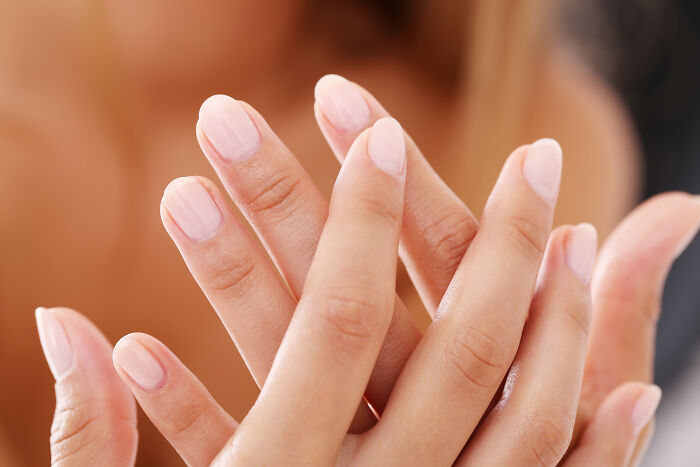 Close-up of hands with clean fingernails, illustrating common hygiene habits.