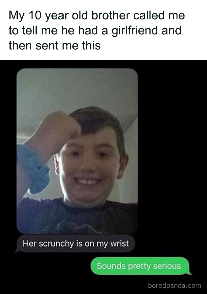 Young boy smiling with a scrunchie on his wrist, sharing a lighthearted text about his new girlfriend; an uplifting meme for positivity.
