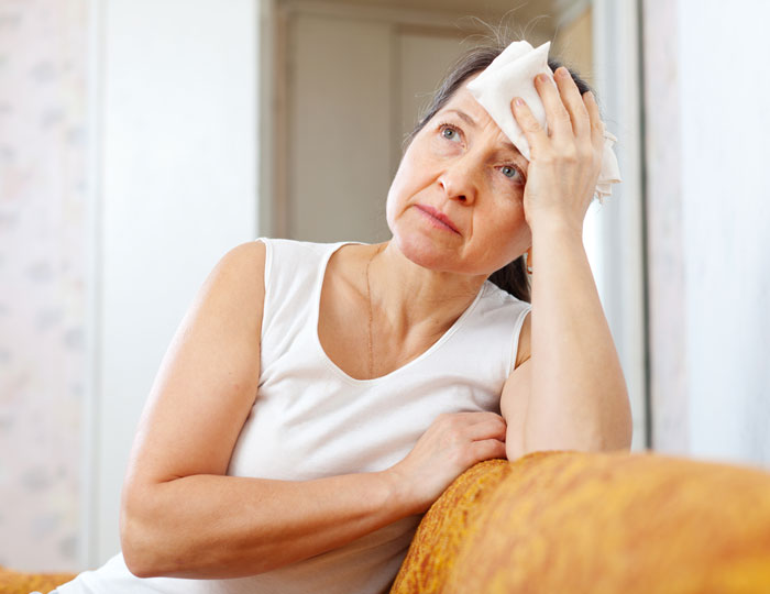 Woman looking upset, holding a cloth to her forehead, expressing emotions related to labor and newborn concerns. Woman looking upset, holding a cloth to her forehead, expressing emotions related to labor and newborn concerns.