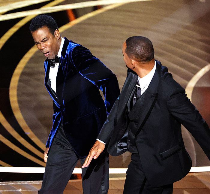 Actors in an award show moment; related to Will Smith, Quincy Jones, and infamous slap incident. Actors in an award show moment; related to Will Smith, Quincy Jones, and infamous slap incident.