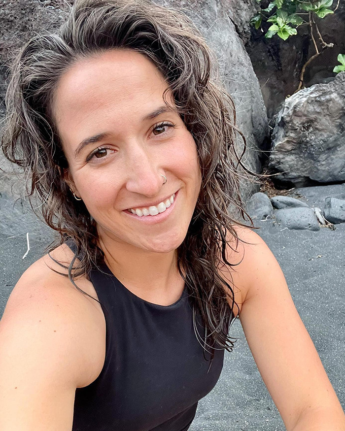 Britt Boril at a rocky beach, smiling for a selfie. Britt Boril at a rocky beach, smiling for a selfie.