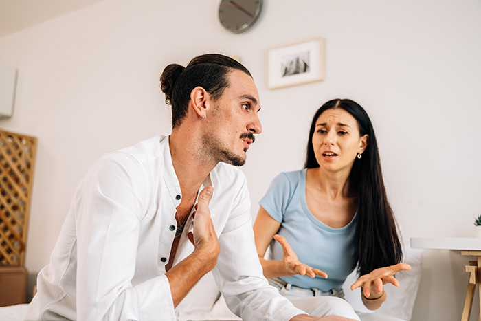 Man and woman discussing, emotions high over dog's ashes, in a bright room. Man and woman discussing, emotions high over dog's ashes, in a bright room.