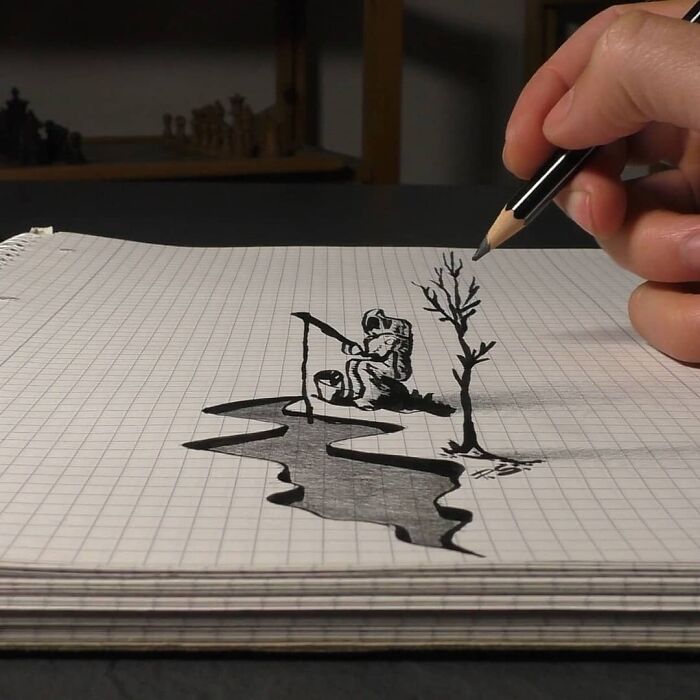 Hand drawing a 3D sketch of a person fishing by water on graph paper, showcasing professional German artist's technique.