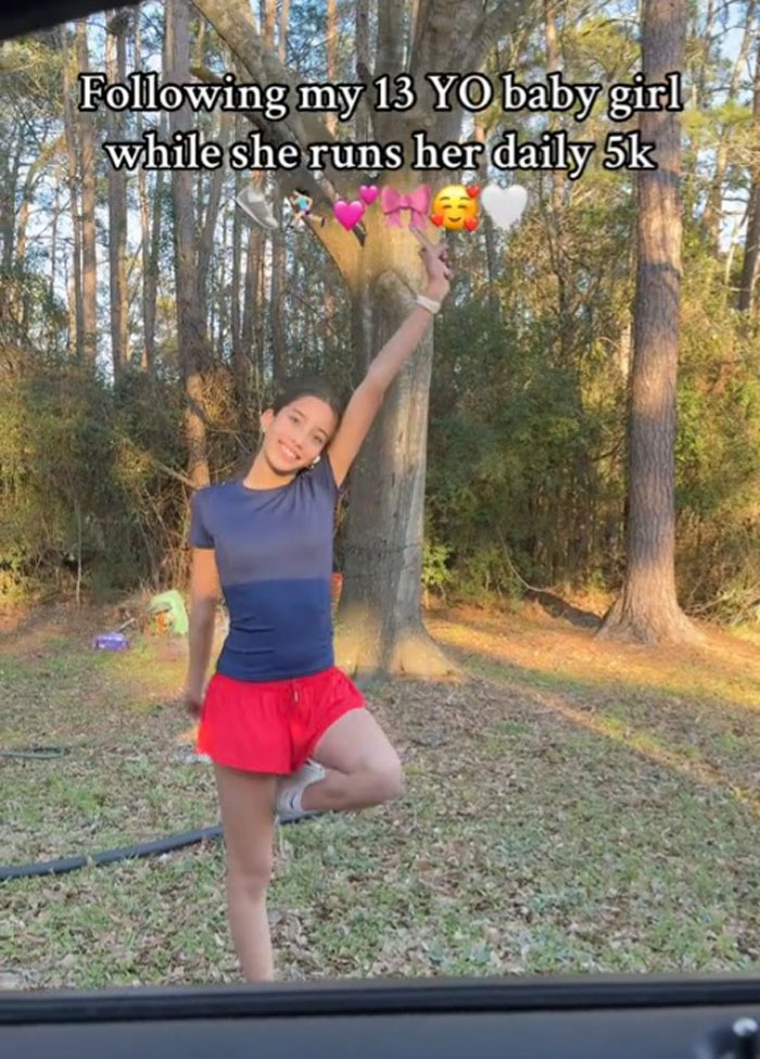 Mother follows daughter during her 5k run, standing in a forest area. Mother follows daughter during her 5k run, standing in a forest area.