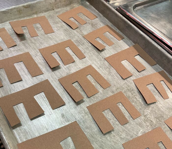 Cardboard letter "E" cutouts on a baking tray for a fun April Fools' prank.