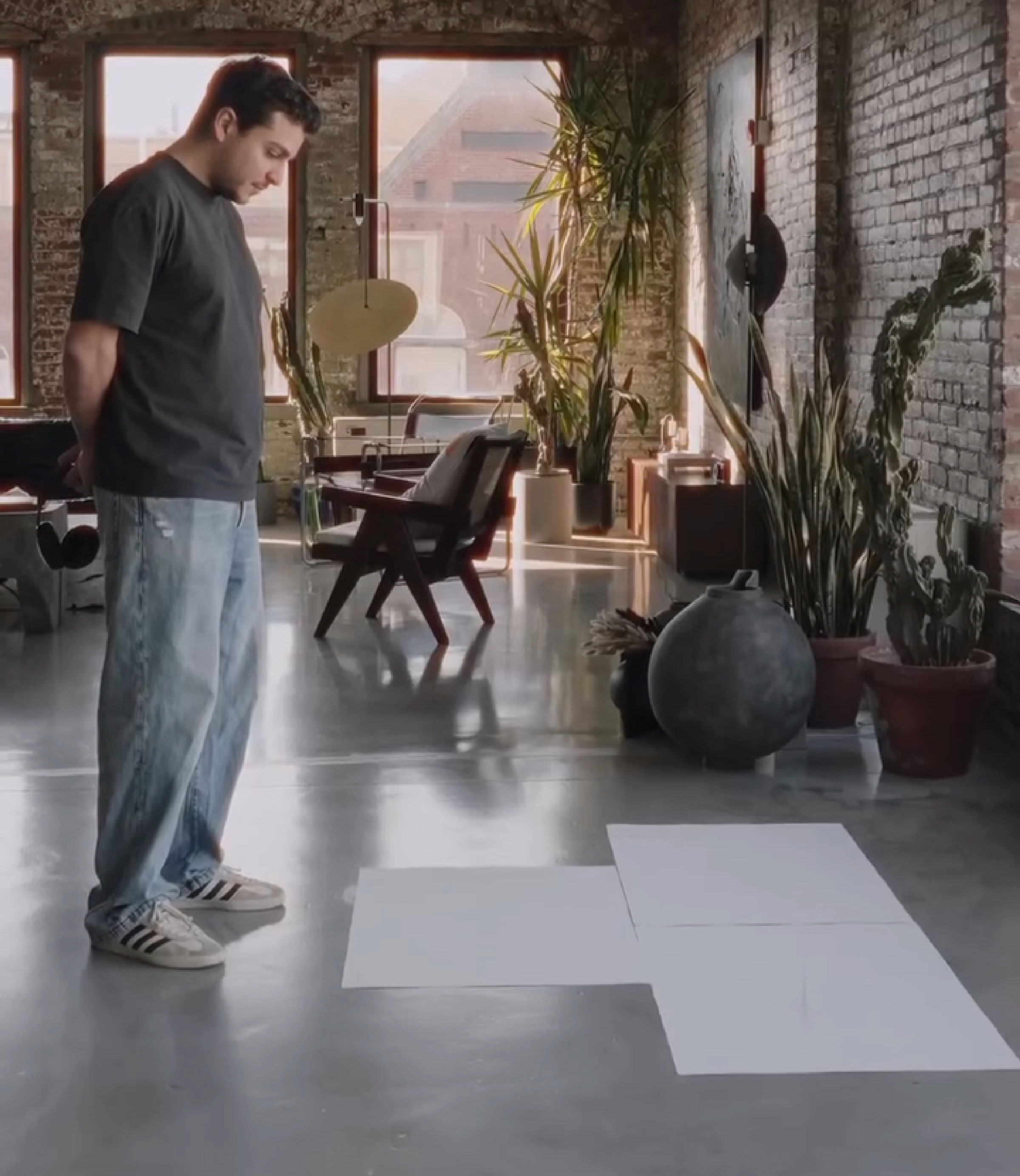 Artist in a loft studio, contemplating unique brain activity imprint tattoo creation on large sheets. Artist in a loft studio, contemplating unique brain activity imprint tattoo creation on large sheets.