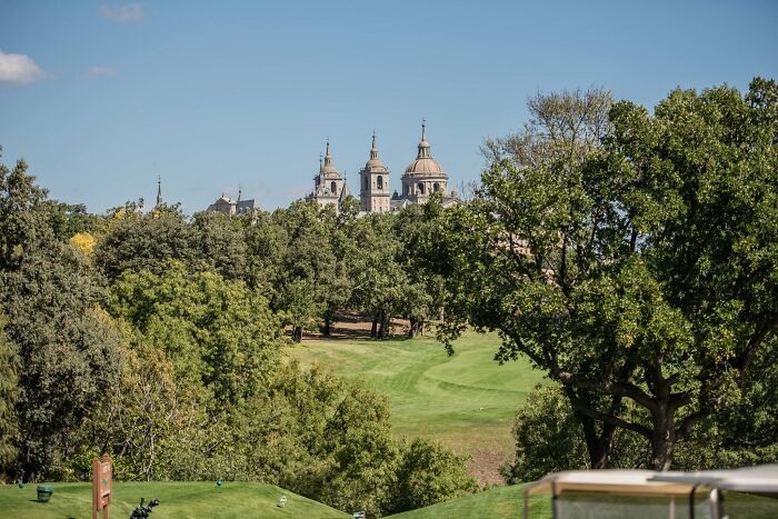 Scenic golf course with lush greenery and historic architecture, a must-visit for golfers seeking breathtaking courses worldwide.