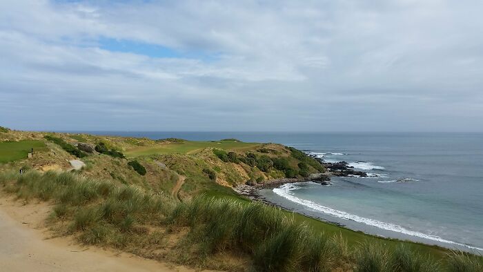 Oceanfront golf course with stunning view of the sea and rugged coastline, attracting golfers from around the globe.