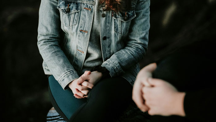 Couple in discussion, one wearing a jean jacket, focusing on relationship dynamics. Couple in discussion, one wearing a jean jacket, focusing on relationship dynamics.