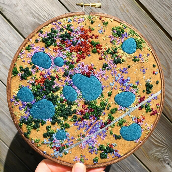 Colorful landscape embroidery by Victoria Rose Richards, featuring abstract floral patterns in a circular hoop.
