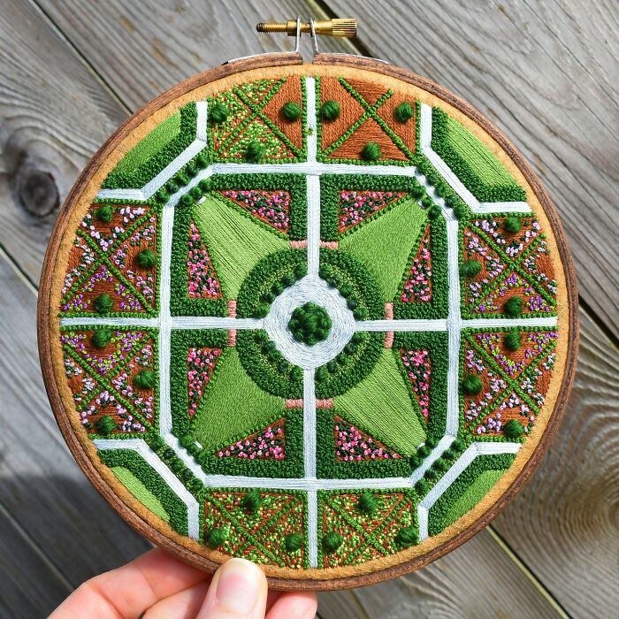 Intricate landscape embroidery with geometric design and vibrant greens and pinks by Victoria Rose Richards.
