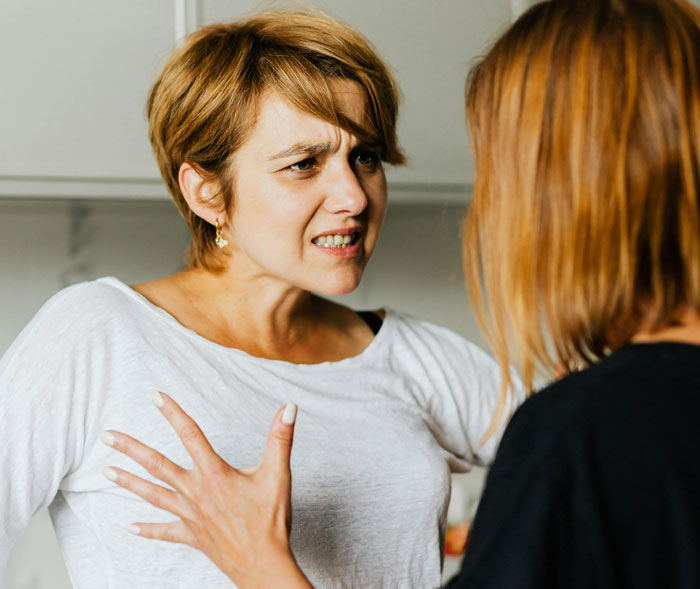 Woman arguing intensely with another woman, embodying a harsh reality check after a babysitting disagreement. Woman arguing intensely with another woman, embodying a harsh reality check after a babysitting disagreement.