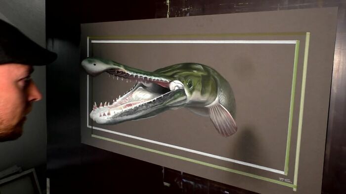 A professional German artist creates a realistic 3D drawing of a fish on canvas.