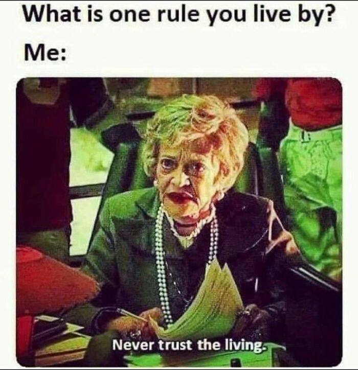 Elderly woman in office, holding papers, with text overlay: "Never trust the living." Spooky and sassy sarcasm meme.