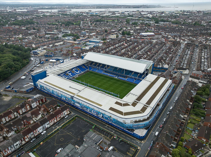 Aerial view of a historic soccer stadium surrounded by urban housing, one of the iconic cathedrals of soccer.
