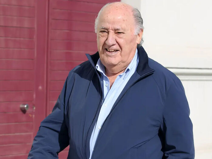 Elderly man smiling outdoors wearing a blue jacket, representing the richest people with more money than most countries.