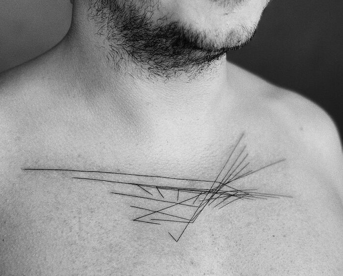 Abstract tattoo on chest depicting unique brain activity imprint with geometric lines. Abstract tattoo on chest depicting unique brain activity imprint with geometric lines.