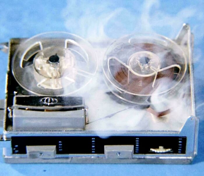 Vintage reel-to-reel tape recorder with smoke, symbolizing nostalgic pics from people realizing they’re old now.