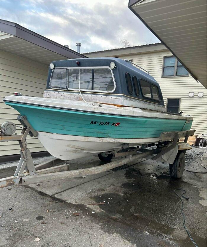 Boat with a homemade camper shell attached, showcasing redneck engineer ingenuity in practical vehicle modifications.