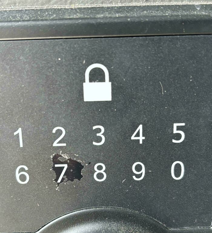 Worn number pad lock with visible wear over number 7, illustrating things used over time.