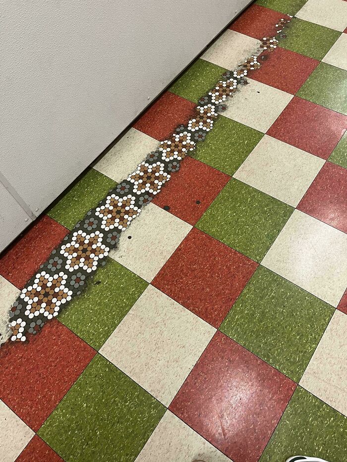 Worn tiles in a colorful pattern show change over time.