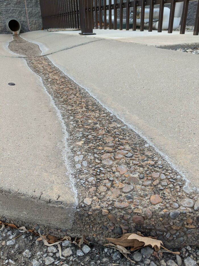 Worn path on concrete showing erosion, illustrating objects used over time.