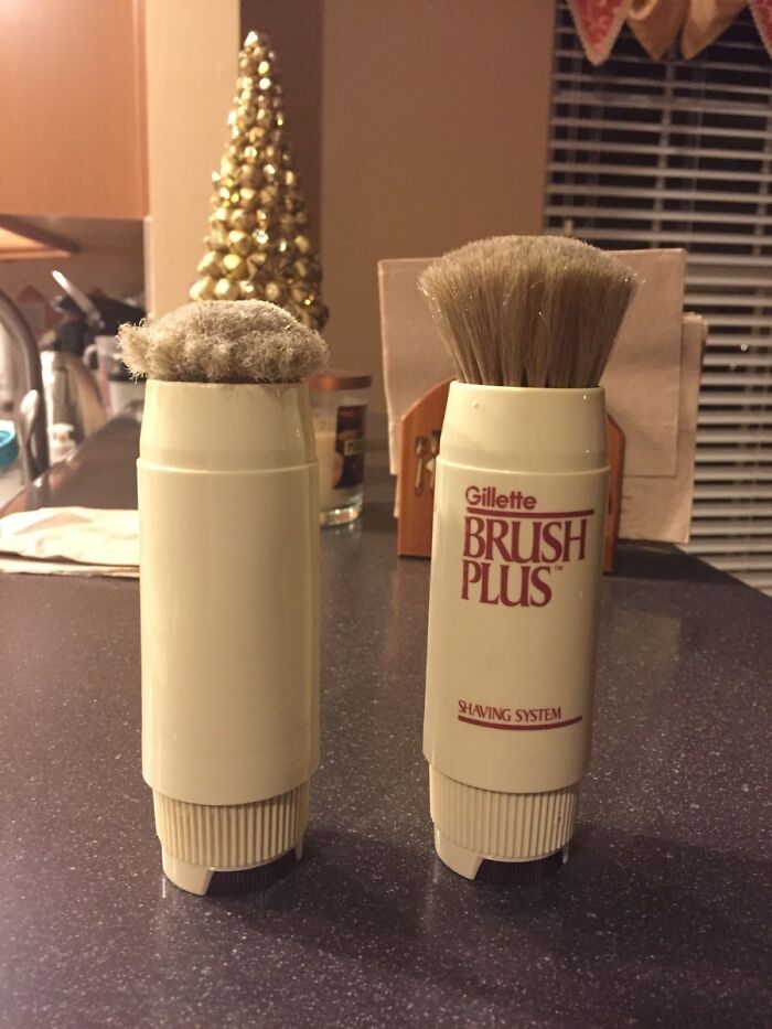 Two shaving brushes on a counter, one worn and used, highlighting the concept of time versus things.