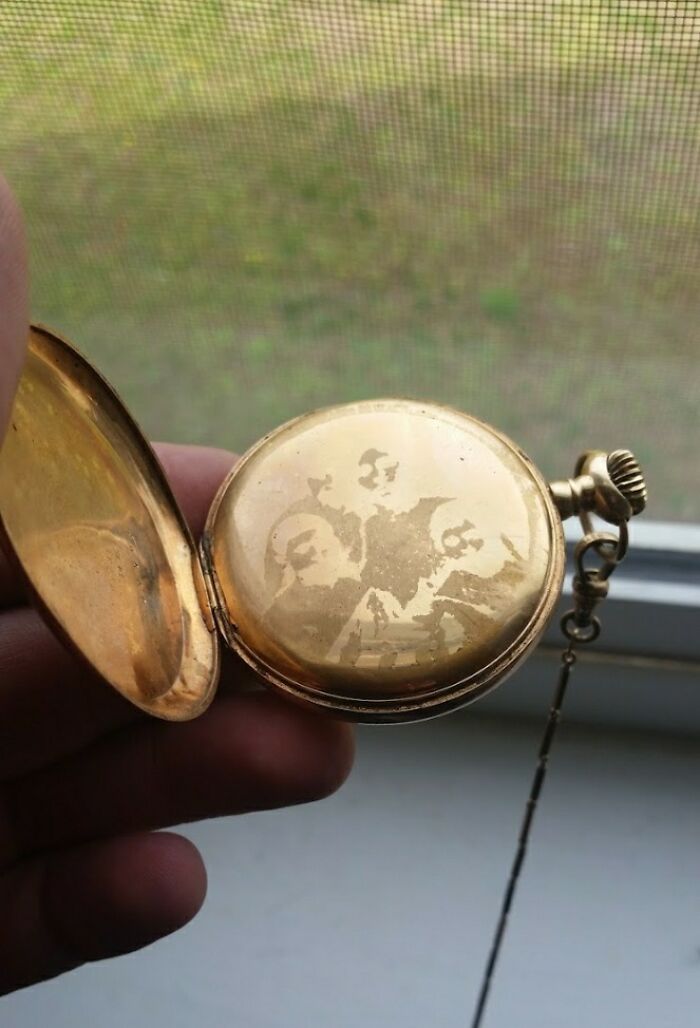 Gold pocket watch with engraved image inside, illustrating the concept of time vs. things.