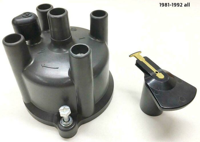 Nostalgic old car ignition distributor cap and rotor parts from 1981-1992, symbols of automotive maintenance.