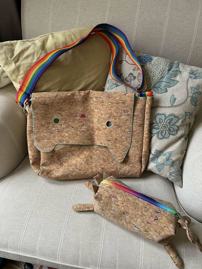 DIY project featuring a cork handbag and pencil case with rainbow straps on a floral cushion.
