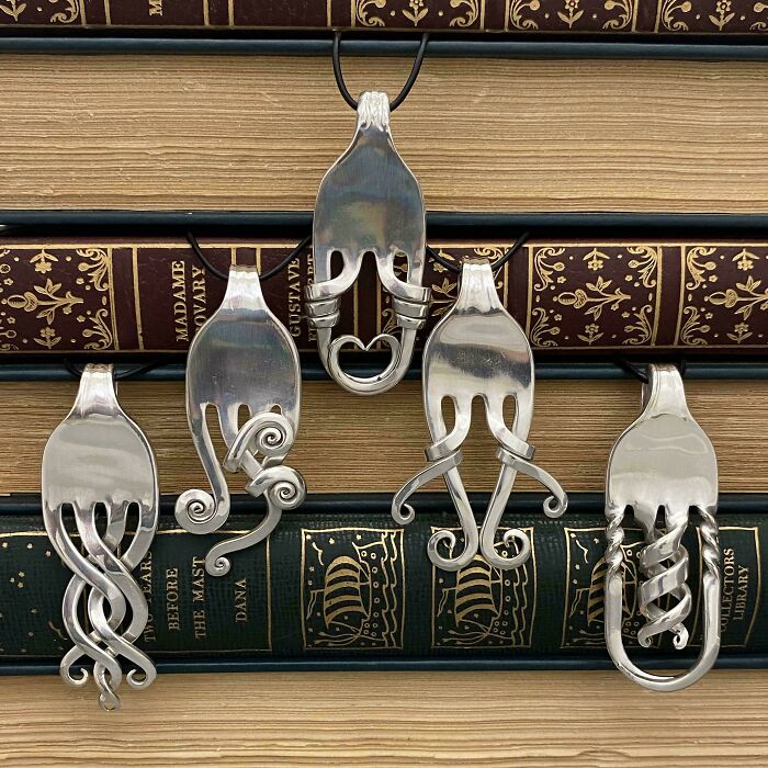 DIY project: repurposed forks into decorative hooks displayed on vintage books.