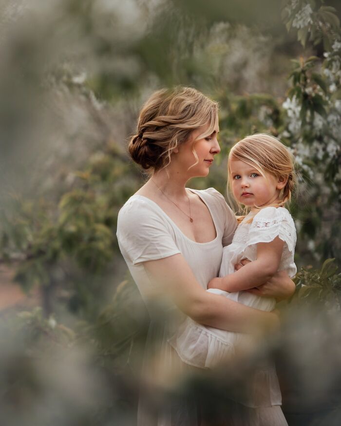 Mother holding child in peaceful garden, capturing the magic of childhood moments through a mother's lens.