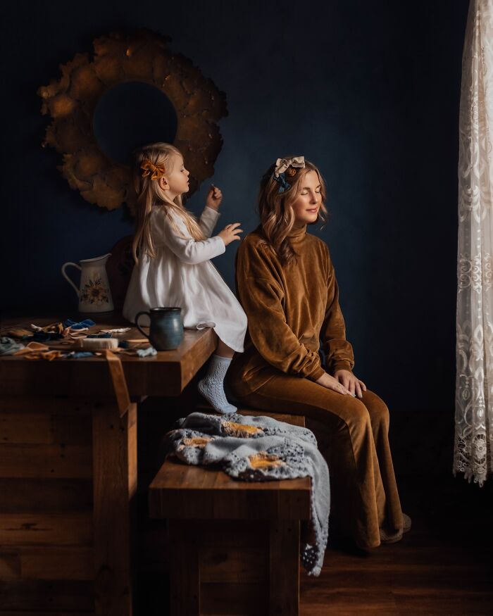 A mother and daughter in a cozy room, capturing the magic of childhood moments through photography.