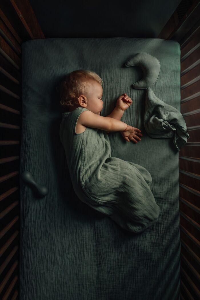 Child peacefully asleep in crib, showcasing the magic of childhood through a mother's lens.