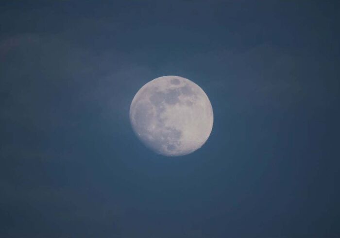Full moon captured in a clear night sky, showcasing astrophotography techniques.