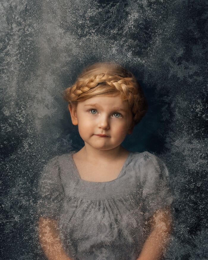 Child with braided hair in a grey dress, embodying the magic of childhood through a mother’s lens.