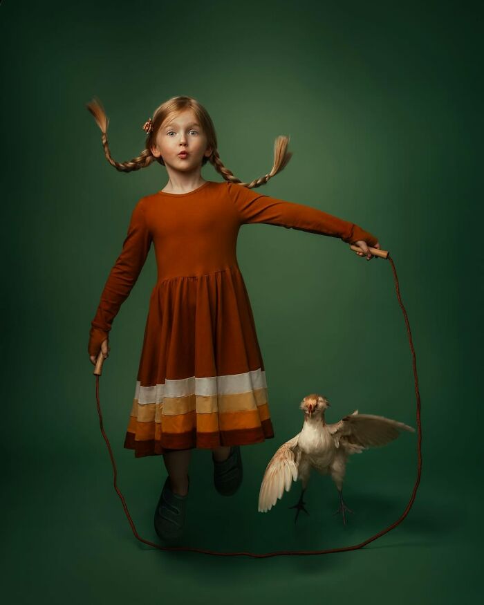 Child jumping rope with a chicken, showcasing the magic of childhood, captured beautifully against a green background.