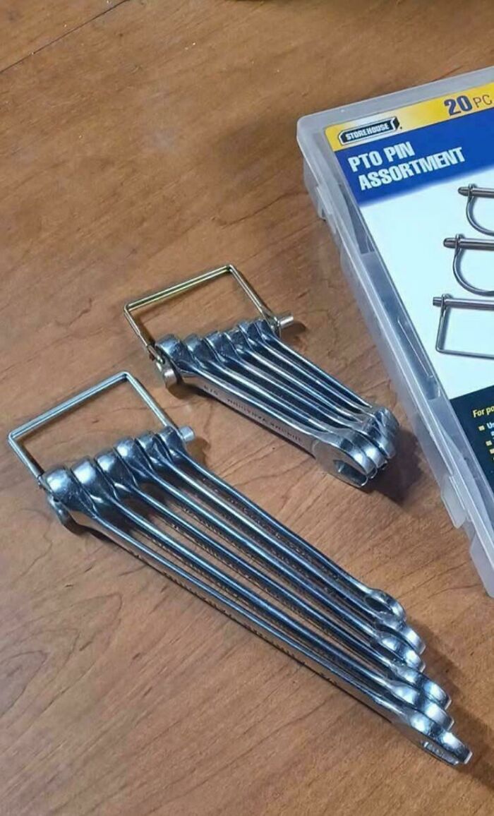 Ingenious redneck engineer creation of a compact wrench set neatly organized with a PTO pin assortment case nearby.