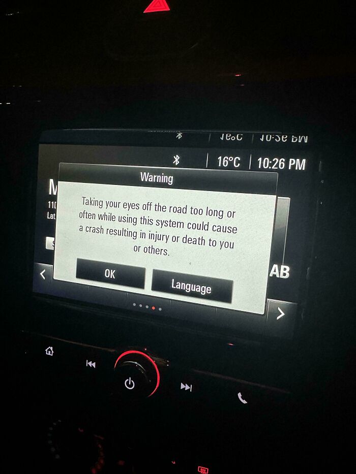 Car dashboard warning about potential crash risk due to distraction, highlighting disastrous design issues.