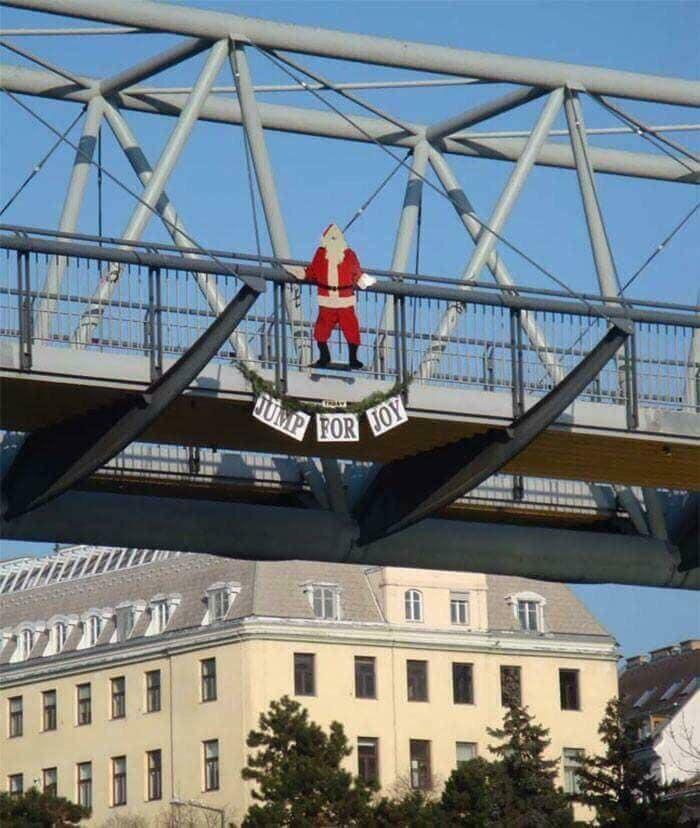 Disastrous design showing Santa dangling over a bridge with a "Jump for Joy" sign.