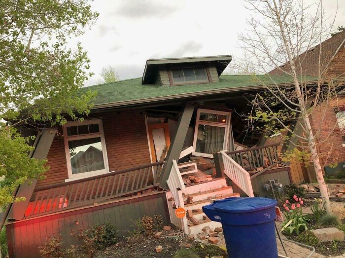 Damaged house with tilted roof and broken porch, a result of poor decisions impacting perfectly good homes.