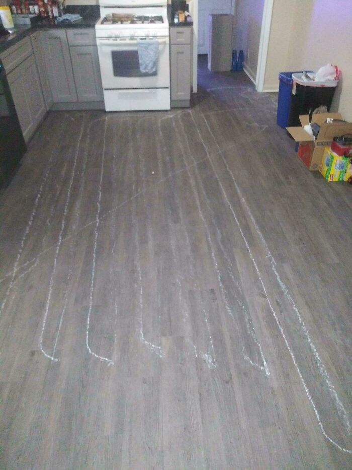 Kitchen floor with visible scratches, illustrating poor decisions in home maintenance.