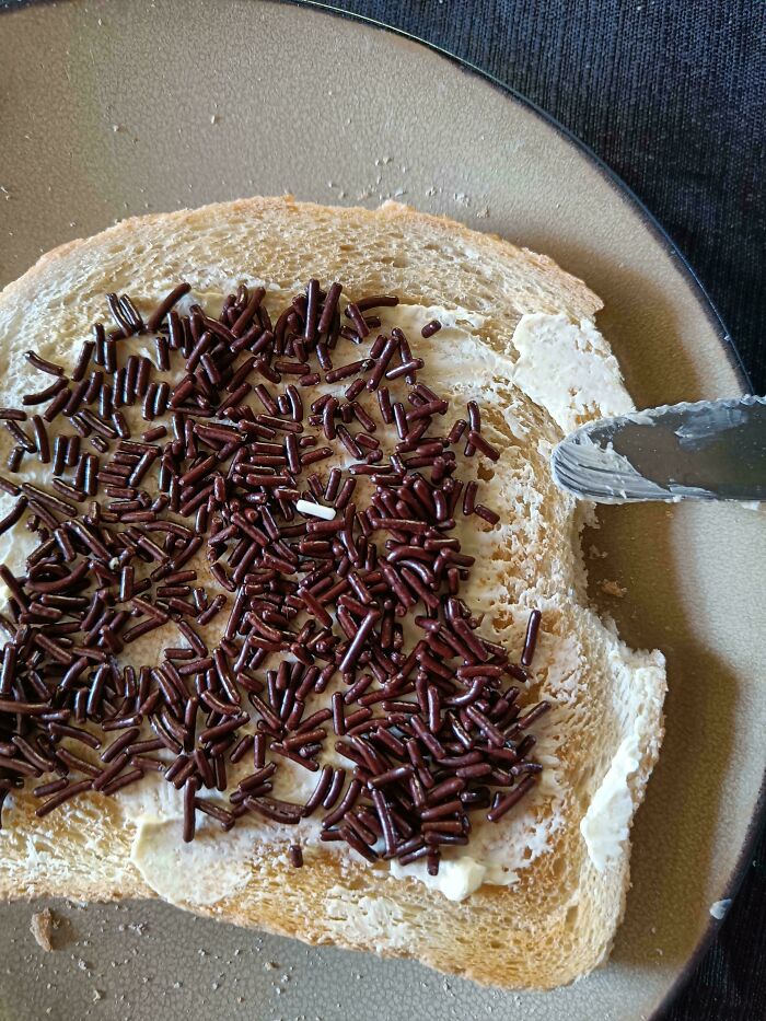 Slice of bread with butter and chocolate sprinkles, symbolizing mundane images.