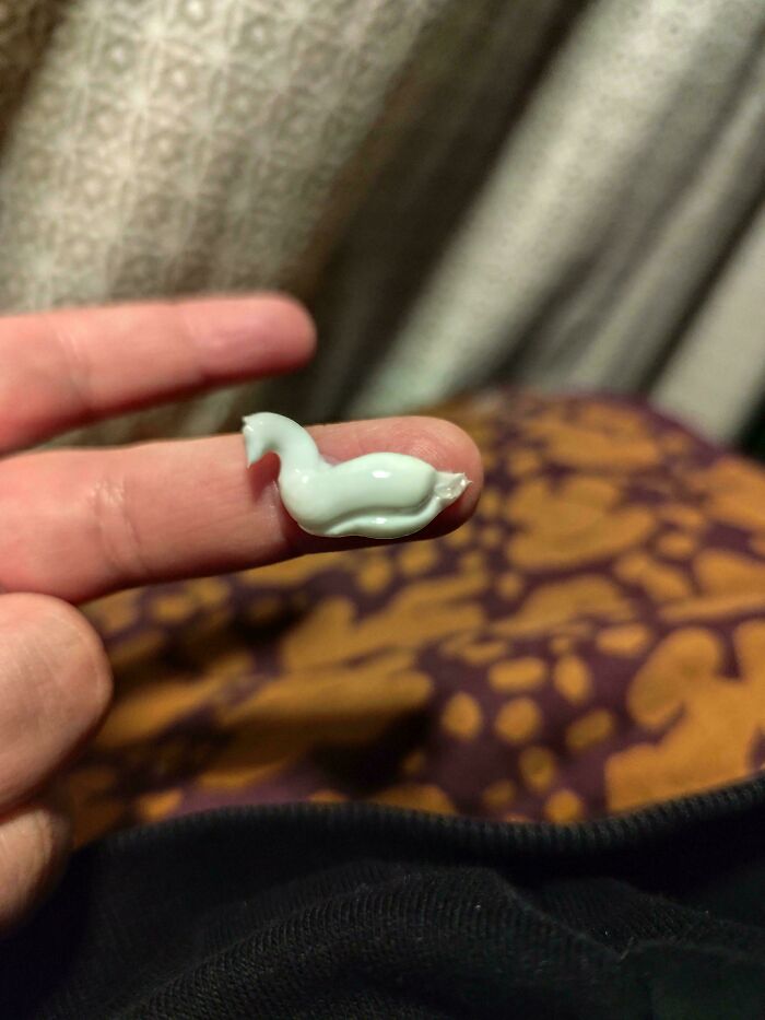 Cream in a whale shape on a finger, showcasing everyday moments.
