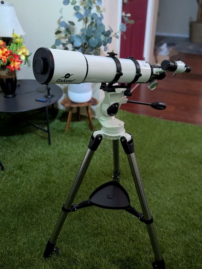 Telescope on a tripod indoors, symbolizing digital detox and reconnecting with nature.