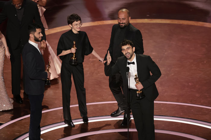 Oscar winners on stage at the Oscars 2025, smiling and holding their awards. Oscar winners on stage at the Oscars 2025, smiling and holding their awards.