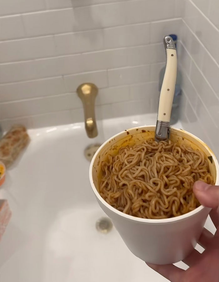 Cup of instant noodles with a knife handle, over a white bathtub, referencing Benny Blanco's shower habit. Cup of instant noodles with a knife handle, over a white bathtub, referencing Benny Blanco's shower habit.