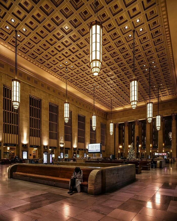 Grand hall of an old American architectural building with ornate ceiling and vintage chandeliers.