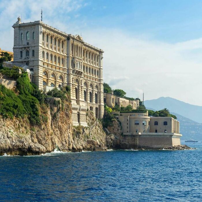Elegant historic building on a rocky coast, showcasing classic architecture by the sea.